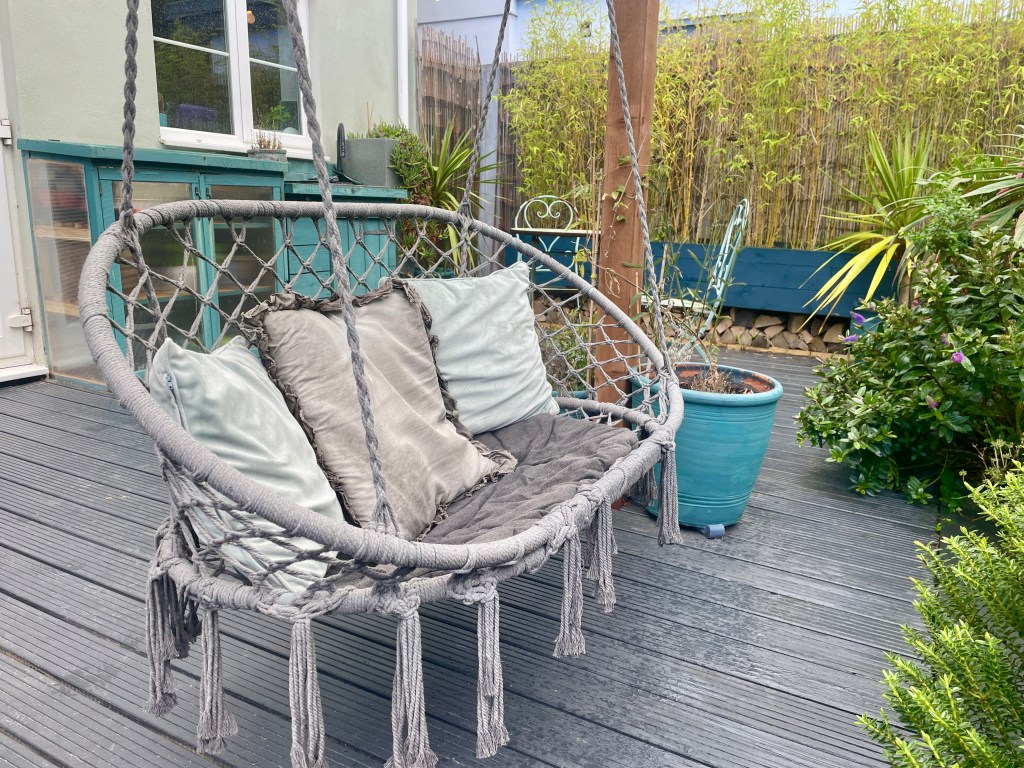 double macrame hanging chair in dark grey in uk garden